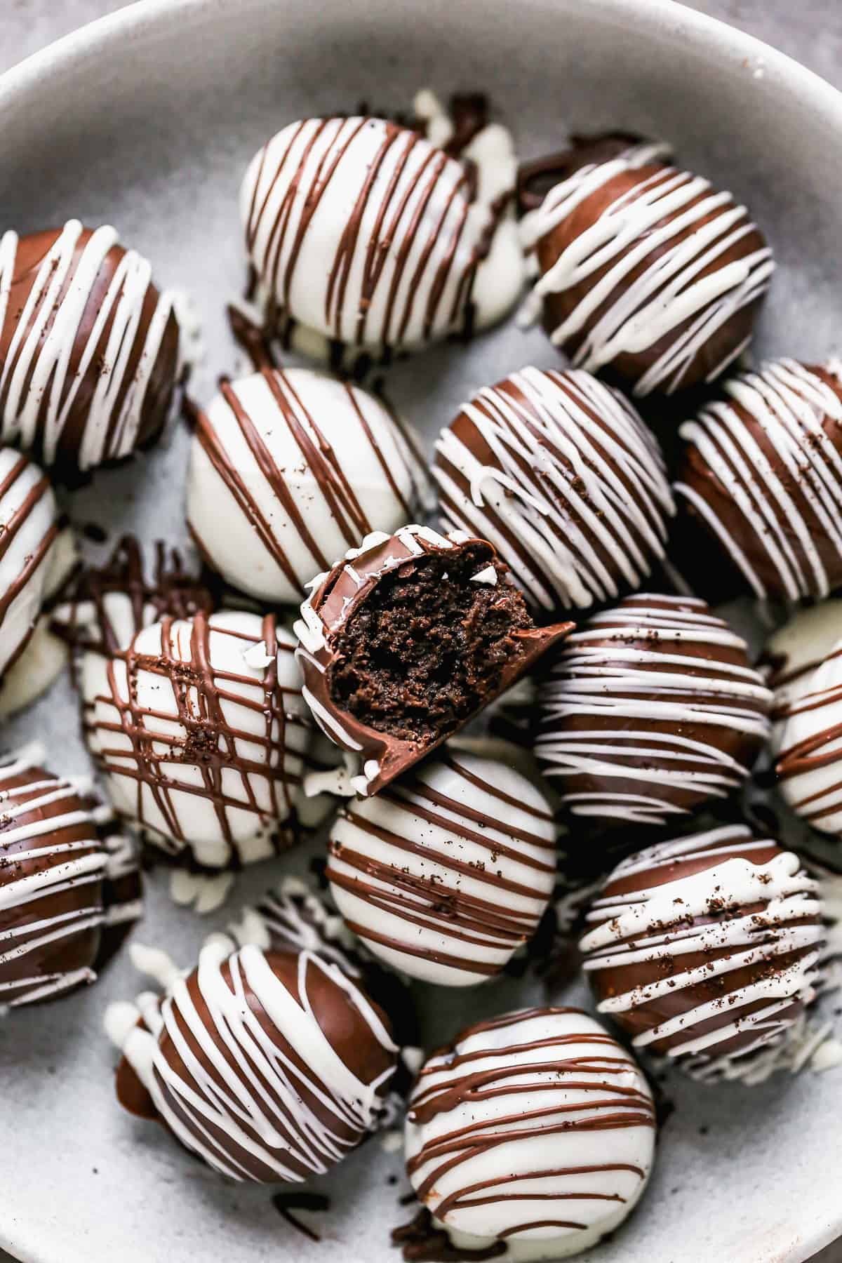 The best Oreo Balls recipe with a bite taken out of one to show the creamy interior.
